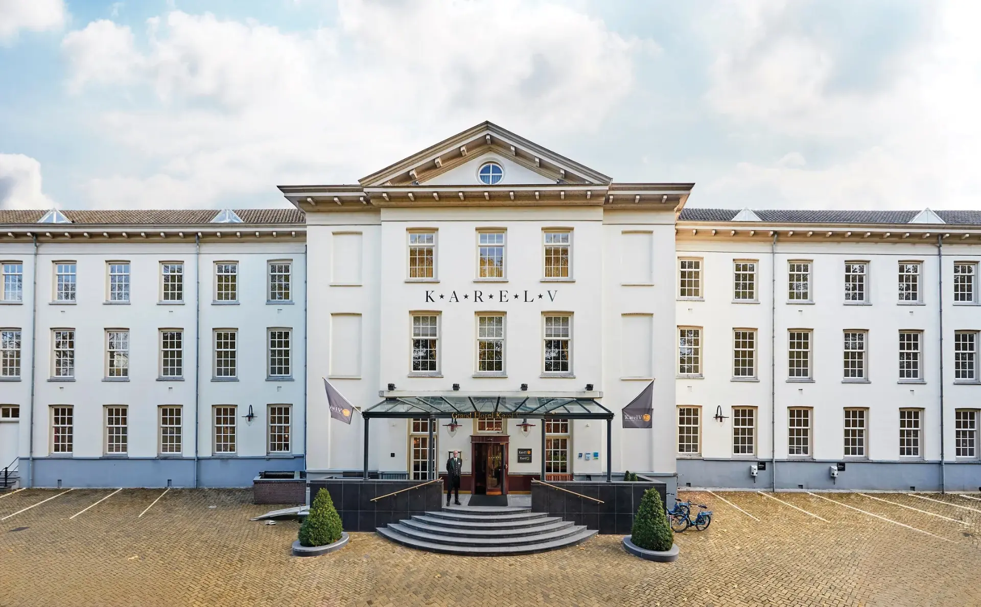 The symmetrical white facade of Grand Hotel Karel V in the historic centre of Utrecht